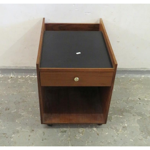 21 - Black Vinyl Topped Retro Teak Bedside Cabinet on castored supports with jewellery drawer to top, ope... 