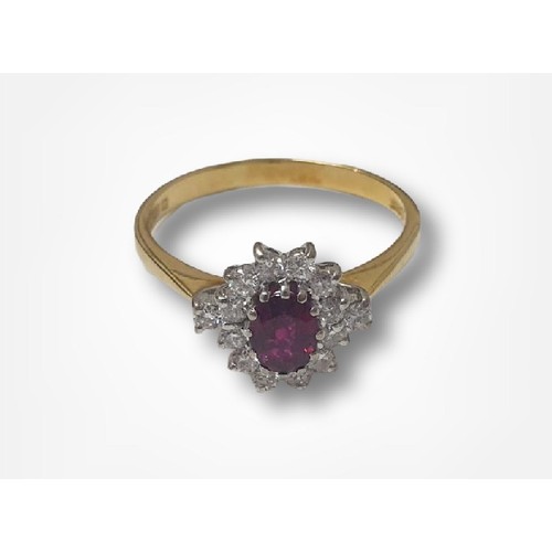 45 - 18ct Gold Ruby & Diamond Cluster Ring, central oval cut ruby approx. 6mm x 4mm with 14 brilliant cut... 