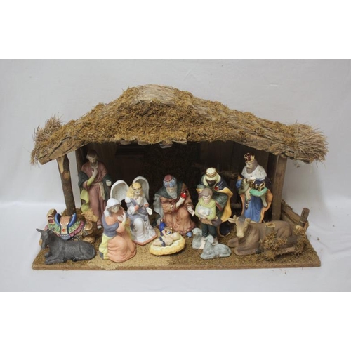 659 - Christmas Nativity Scene with stable, thatched roof approx. 70cm L & ceramic figures Mary, Joseph ap... 