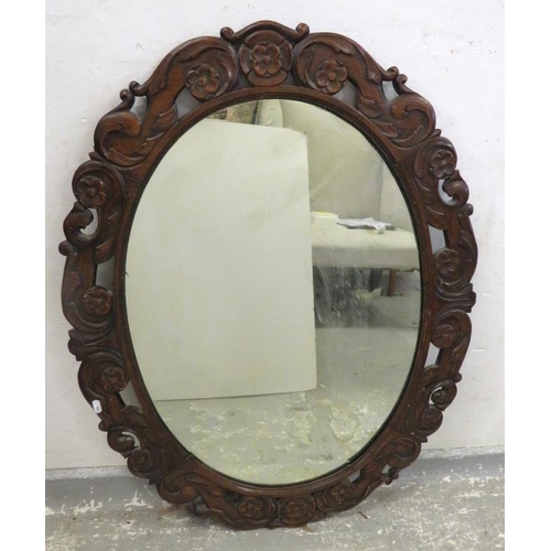 136 - Large Oval Wall Mirror with carved rose & C-scroll flowerhead frame approx. 92cm x 70cm A12