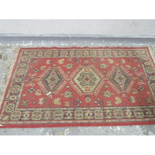 61 - Red & Cream Rug, tassel ends, woven edges approx. 1m x 64cm A5