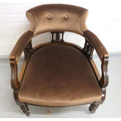 Low Brown Upholstered Tub Chair with Pierced arm supports on turned