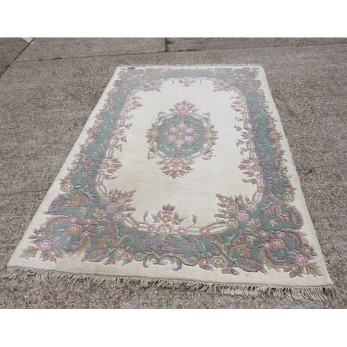 19A - Oriental Carpet, cream ground with blue surround, pink flowers, approx. 274cm x 178cm