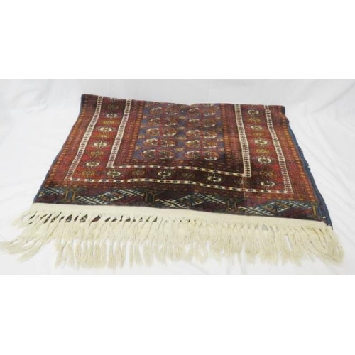 Maroon Ground Persian Rug with white tassels approx. 57cm x 110cm