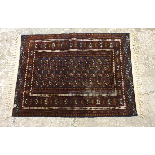 Maroon Ground Persian Rug with white tassels approx. 57cm x 110cm