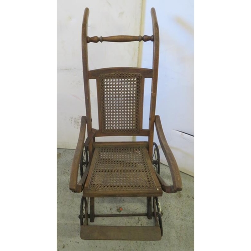 6 - Victorian Folding Wheelchair with rattan seat & back, metal framework on spoked wheels FW