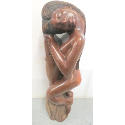 23 - Carved African Sculpture depicting a nude resting on a rock, signed to base, approx. 110cm H (FW)