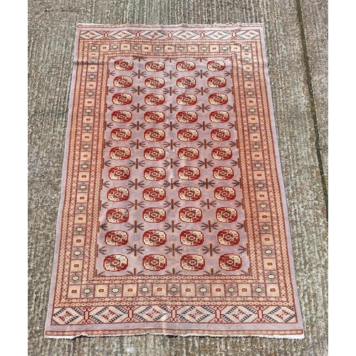 71A - Beige Ground Pakistani/Bukhara/Persian Style Rug decorated with red lozenges approx. 220cm x 140cm (... 