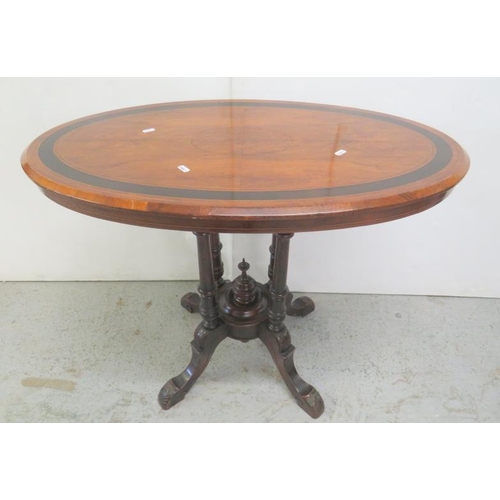 18 - Victorian Oval Walnut Loo/Side Table on 4 turned column supports, carved feet with burrwood quarter ... 