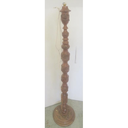 31 - Teak Oriental Carved Standard Lamp with decoration of dragons with cream shade approx. H160cm x base... 