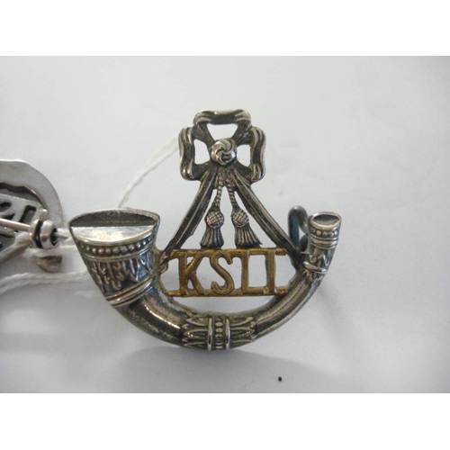 111 - A King's Shropshire Light Infantry silver and paste set sweetheart brooch: together with a KSLI cap ... 