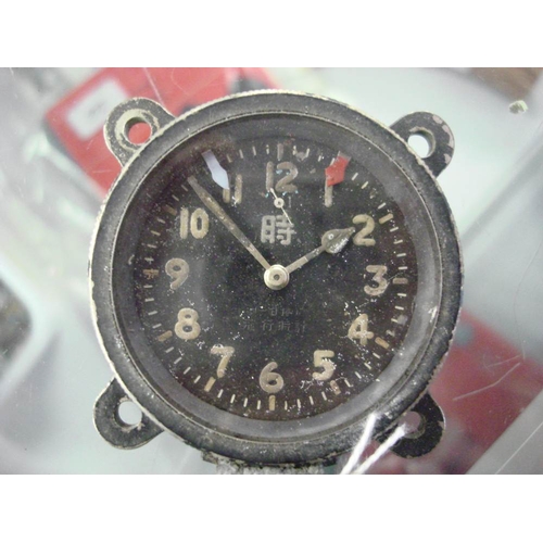 141 - A WWII Japanese Seikosha Model 100 aircraft clock: the black dial with luminous Arabic numerals and ... 