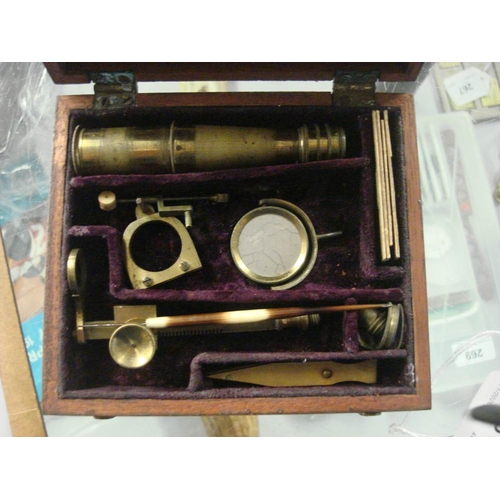 261 - An early 19th century lacquered brass field microscope, unsigned:, the 4 inch main tube on a rack an... 