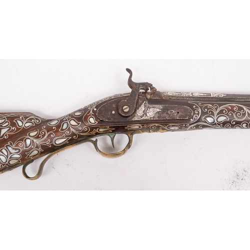 62 - A 19th century Turkish mother of pearl inlaid percussion cap rifle: the 28 1/2 inch two stage barrel... 