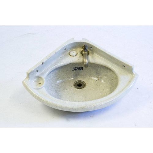 786 - A LMS cabin earthenware corner sink: with short splashback and single tap, the bowl marked 'LMS' in ... 