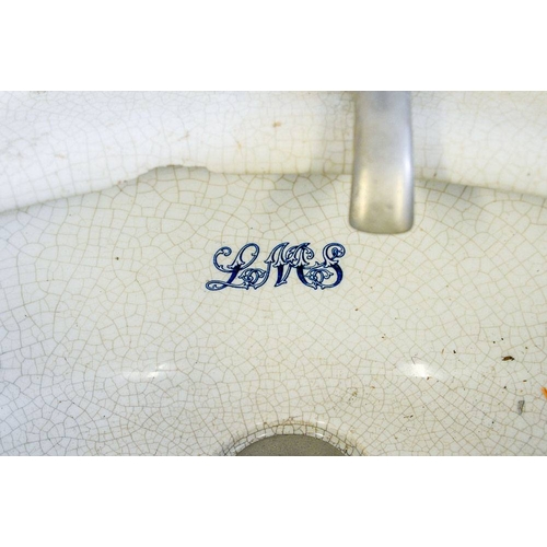 786 - A LMS cabin earthenware corner sink: with short splashback and single tap, the bowl marked 'LMS' in ... 