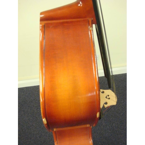 873 - A three quarter size double bass:, unsigned, with scroll carved headstock and brass keys, over body ... 