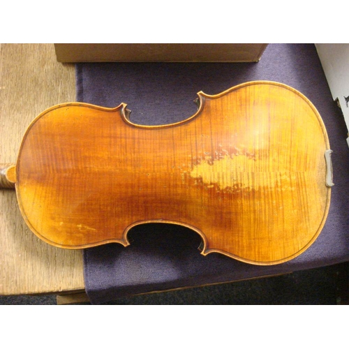 877 - A Czechoslovakian violin: scroll carved headstock over ebony finger board and body with two piece ba... 