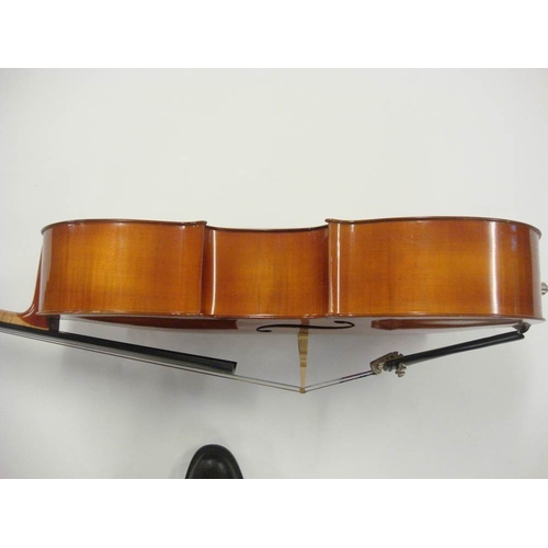 883 - A 20th century German cello:, scroll carved headstock with ebony keys and fingerboard, two piece fla... 