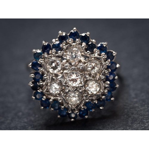 1114 - A sapphire and diamond circular cluster ring: set with round brilliant-cut diamonds within a border ... 