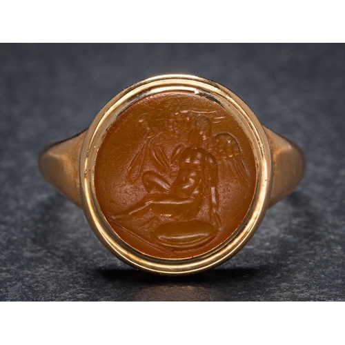 1118 - A Roman cornelian intaglio mounted seal ring: the intaglio possibly depicting the Roman god Cupid wi... 