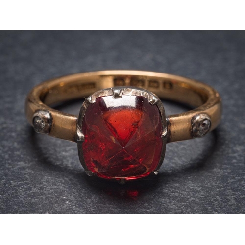 1121 - A red spinel and diamond mounted three-stone ring: the rectangular red spinel within a silver cut-do... 