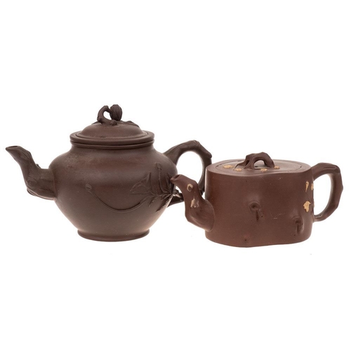 1166 - Two Chinese Yixing stoneware teapots: one of dark brown hue with rustic handle, spout extending into... 