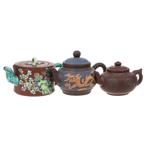 1172 - Three Chinese Yixing stoneware teapots: of various hues comprising a banded cylindrical example with... 
