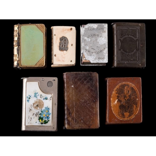 836 - A collection of seven assorted book-shaped vesta cases: including ivory and horn examples (7).