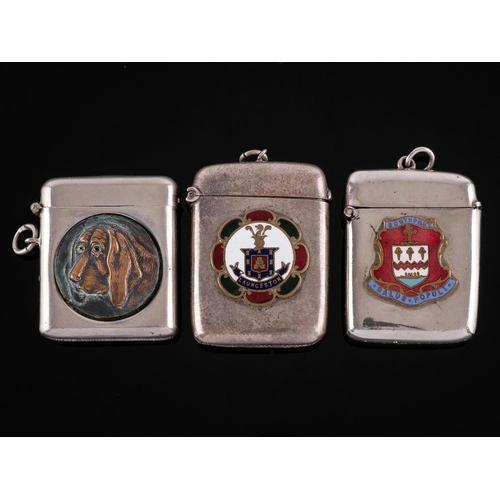 843 - Two silver plated vesta cases: of rectangular outline bearing enamel coats-of-arms and another vesta... 