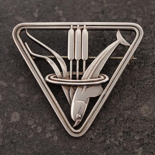 172 - Georg Jensen. A silver rounded triangular brooch design number 257: depicting a dolphin and bulrush ... 