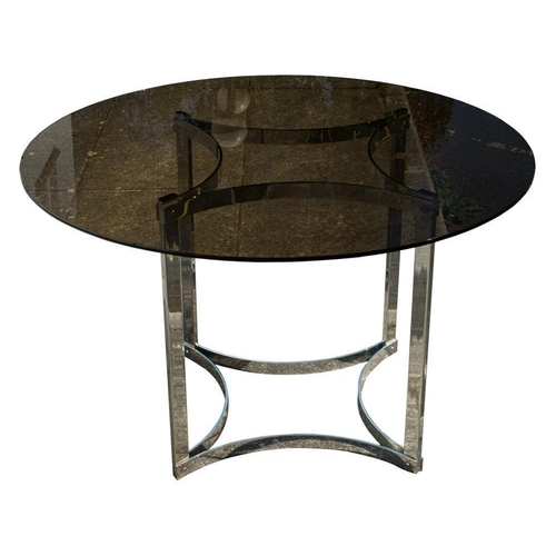 299 - A smoked glass circular dining table on stainless steel base: with concave stretchers to top and bas... 