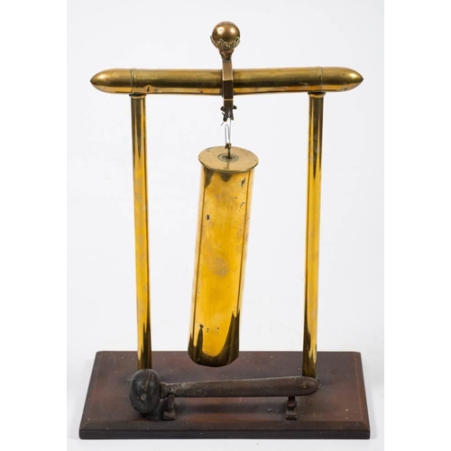 280 - A trench art shell case dinner gong: the shell suspended between two brass column supports with ball... 