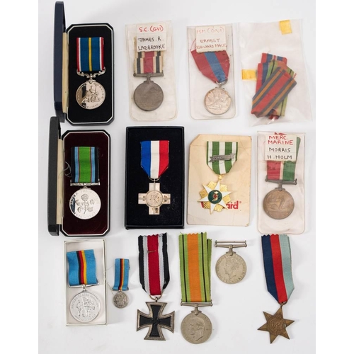 285 - A group of WWII and later medals: including a George VI Imperial Service Medal to Ernest Edward Mace... 
