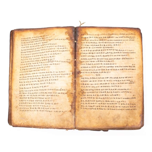 373 - HOLY BOOK : hand written in a Coptic script, on heavily stained vellum, stitched together in nine ga... 