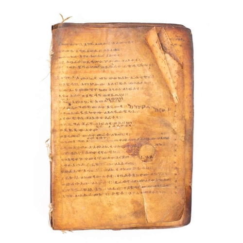 373 - HOLY BOOK : hand written in a Coptic script, on heavily stained vellum, stitched together in nine ga... 