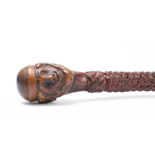 146 - Ray Tucknott. A knotwork walking cane with cared head pommel: 130cm   *Notes- Ray Tucknott joined th... 