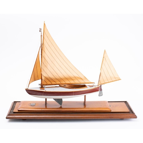 18 - A cased model of the canoe yawl 'Crayfish' 1898-1901: fully rigged over detailed deck and cockpit, t... 