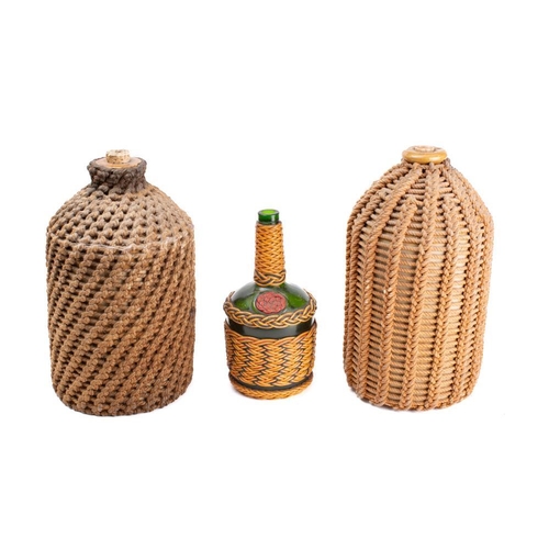 229A - Ray Tucknot. A small ropework display board together with three ropework bound bottles: (4)