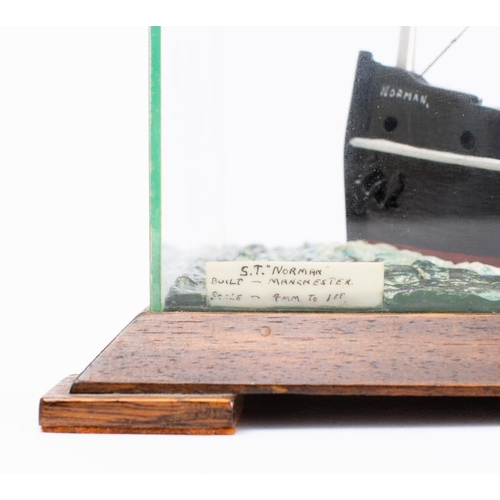 244 - A cased waterline model of the steam tug 'Norman' of Manchester, modelled by W Greenhalgh:  carved a... 