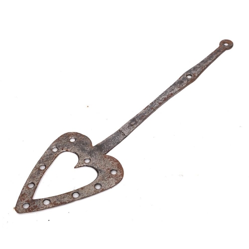 242 - A steel cooking slice: of pierced heart shape with shaped handle and ring terminal, 55cm long, 18th ... 