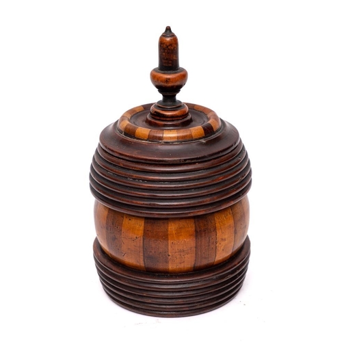 249 - A lignum vitae biscuit barrel and cover: with acorn finial, ribbed and simulated fluted sides and in... 