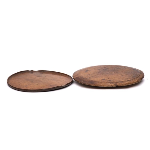 282 - A circular fruitwood tray:, 41cm diameter, also a circular wood chopping board adapted as a lazy sus... 