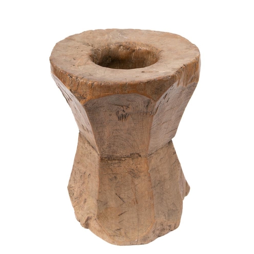 296 - A 19th Century rustic wooden mortar: with polygonal angled sides.