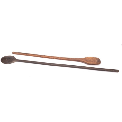 303 - Two wood cauldron stirrers: with turned handles.