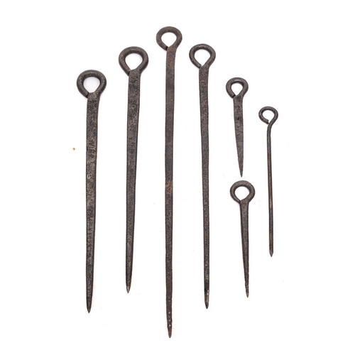 379 - A collection of seven early iron meat skewers: of varying sizes.