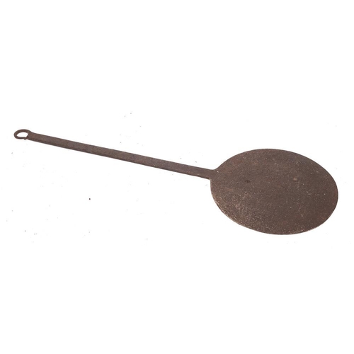 397 - An iron griddle plate or baking iron: with tapered handle, 37cm diameter, another smaller, 21cm diam... 