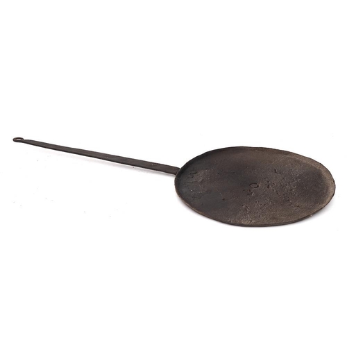 397 - An iron griddle plate or baking iron: with tapered handle, 37cm diameter, another smaller, 21cm diam... 