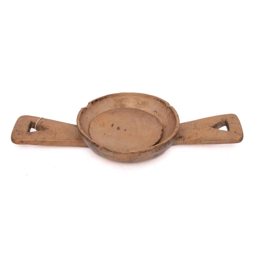 41 - A sycamore twin-handled cheese strainer: with press, the circular bowl having twin handles with tria... 