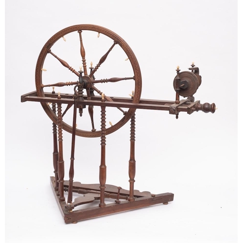 429 - A 19th Century fruitwood spinning wheel: with turned baluster spindle spokes, having turned uprights... 